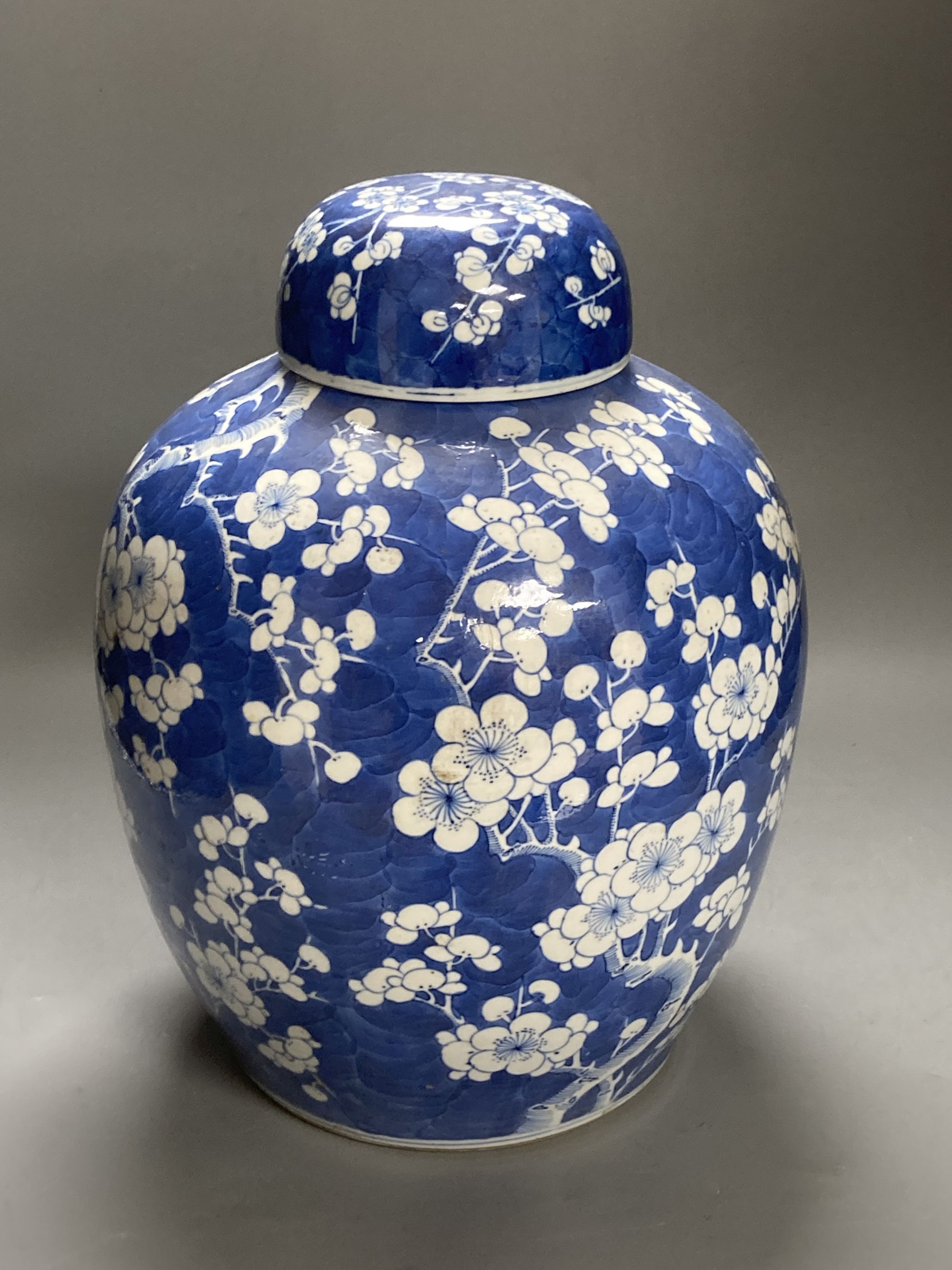 A large 19th century Chinese blue and white prunus jar and cover, height 35cm, and a late 20th century Chinese blue and white stick sta